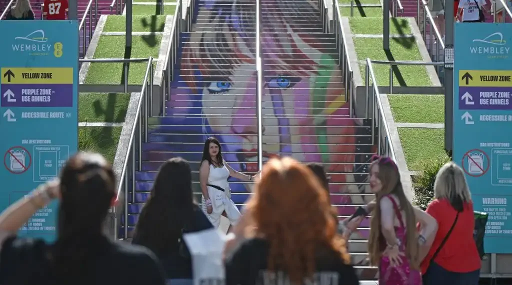 Los fans de la megaestrella estadounidense Taylor Swift, los llamados "Swifties", posan para fotografías en el exterior del estadio de Wembley en Londres. (AFP)