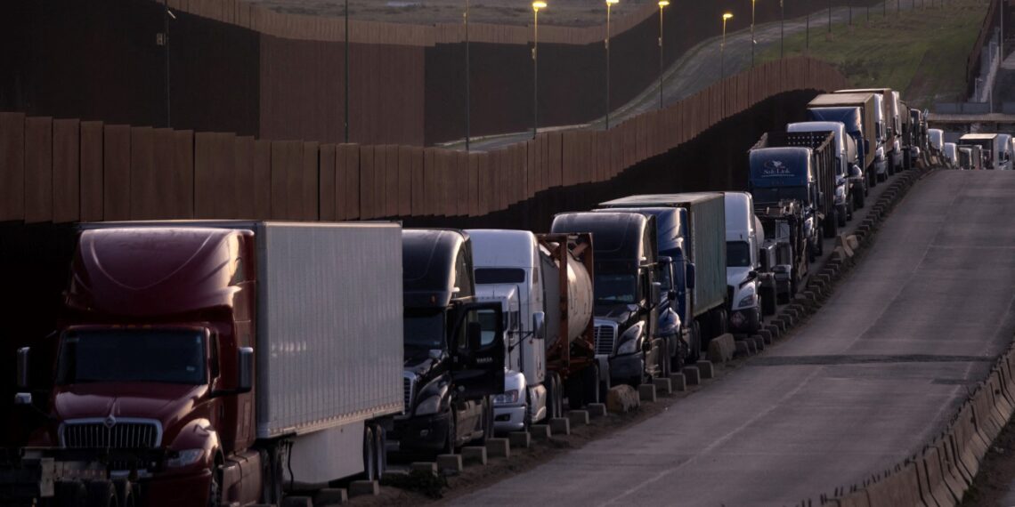 Trucks queue near the Mexico-US border before crossing the border at Otay Commercial crossing in Tijuana, Baja California state, Mexico, on March 4, 2025. Stinging US tariffs on Canadian and Mexican goods came into effect as a deadline to avert President Donald Trump's levies passed without the nations striking a deal -- a move set to snarl supply chains. Mexico will hit back at Trump's tariffs with retaliatory duties of its own, President Claudia Sheinbaum said, accusing Washington of "defamatory" claims against her government. (Photo by Guillermo Arias / AFP)